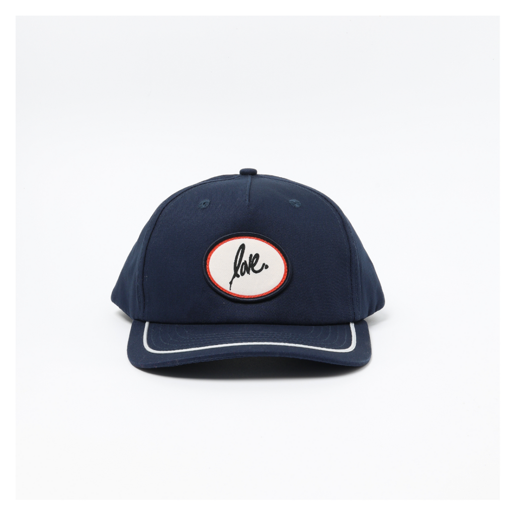 Navy blue cap with a circular Ruben Rojas love logo on a white background