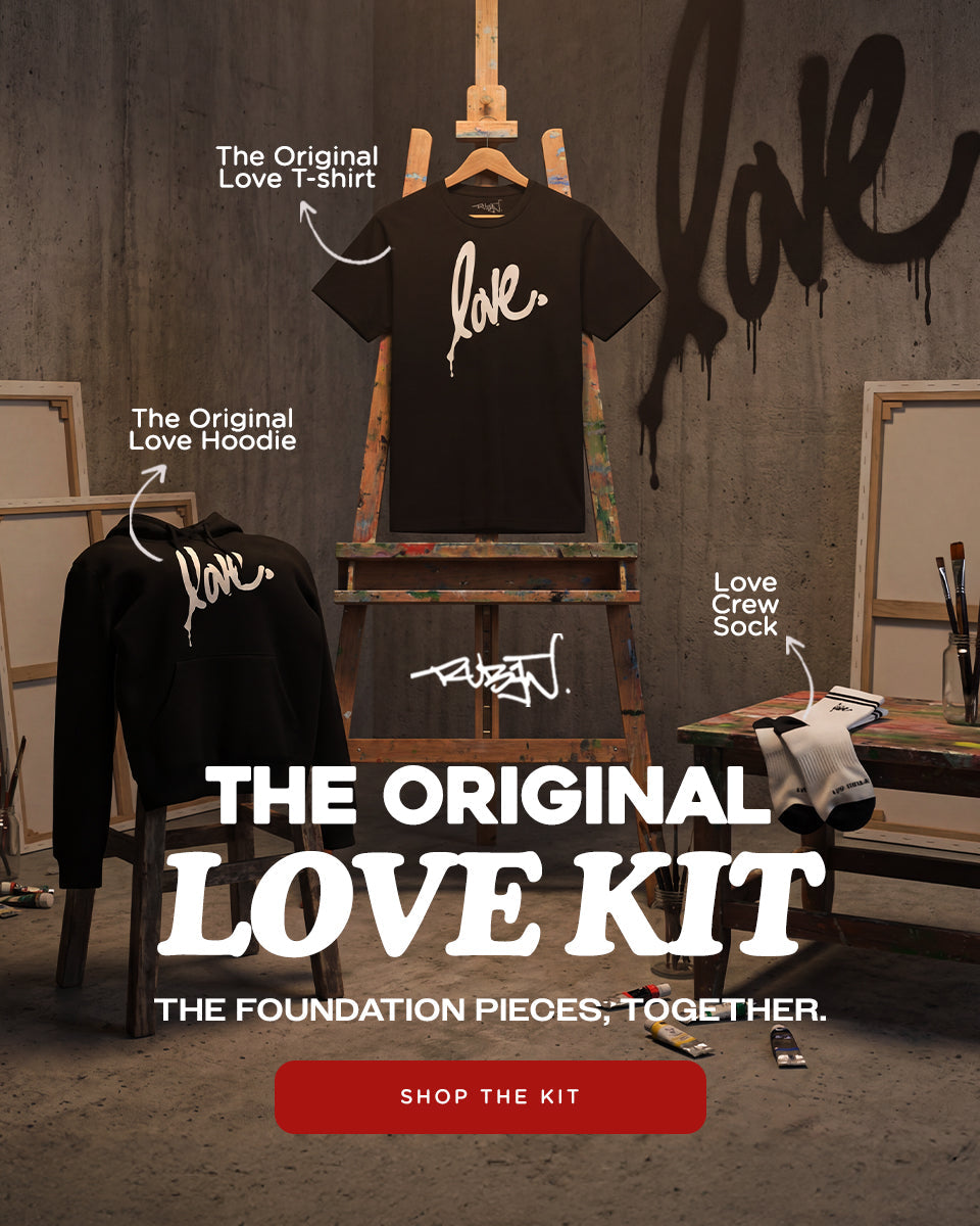 Promotional image of 'The Original Love Kit' with clothing and 'love' graffiti on a wall.