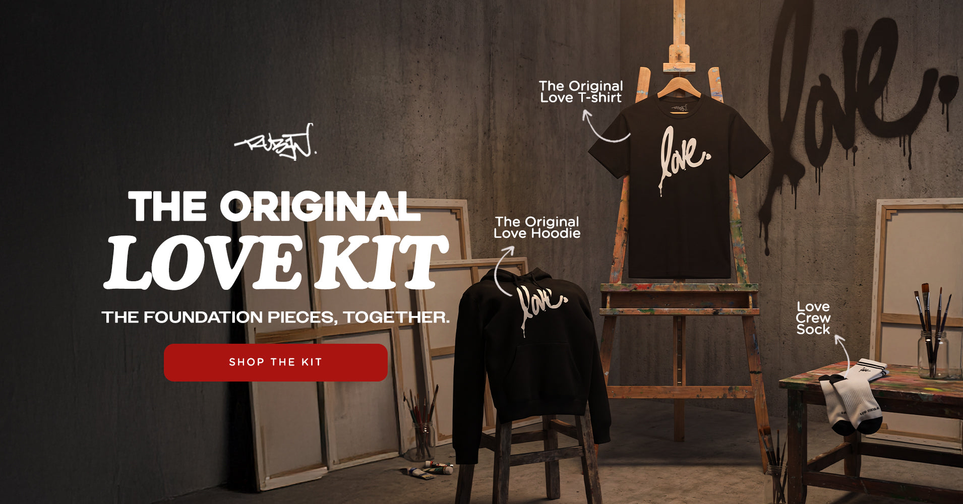 Promotional image of 'The Original Love Kit' with t-shirt, hoodie, and sock displayed against a dark wall.