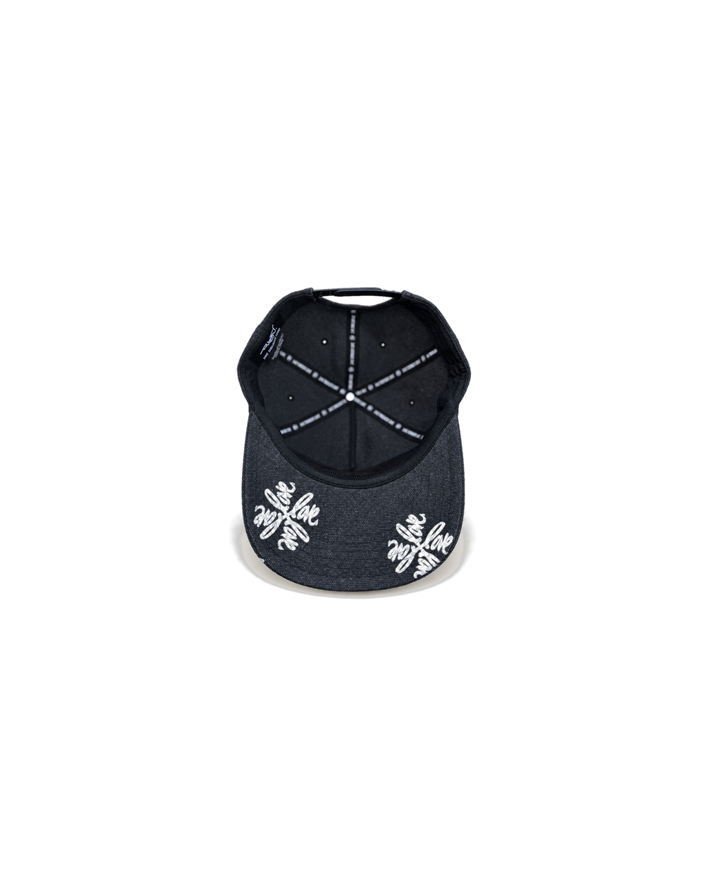 Love Flower Cap in Night Bloom black, underbrim view with Love Flower print and Live Through Love interior taping