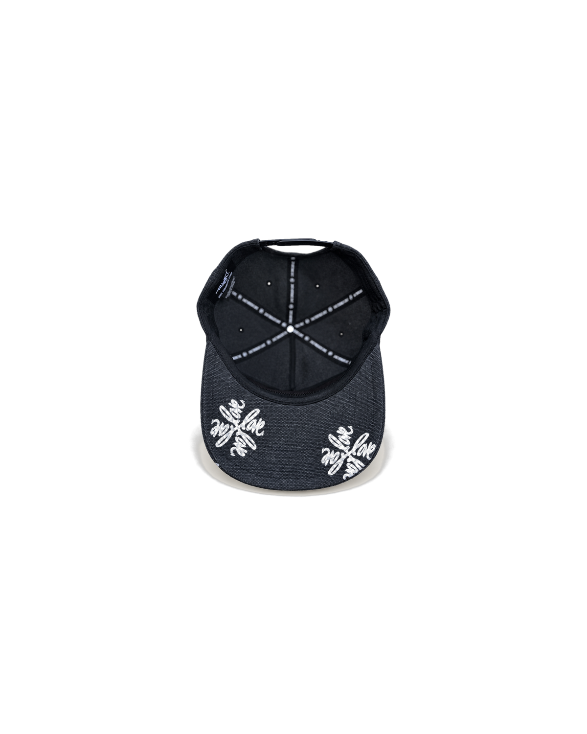 Love Flower Cap in Night Bloom black, underbrim view with Love Flower print and Live Through Love interior taping