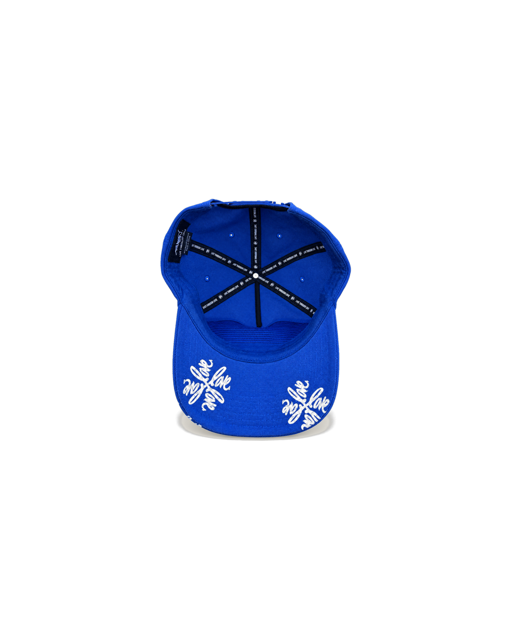 Love Flower Cap in Full Bloom royal blue, underbrim view with Love Flower print and Live Through Love interior taping