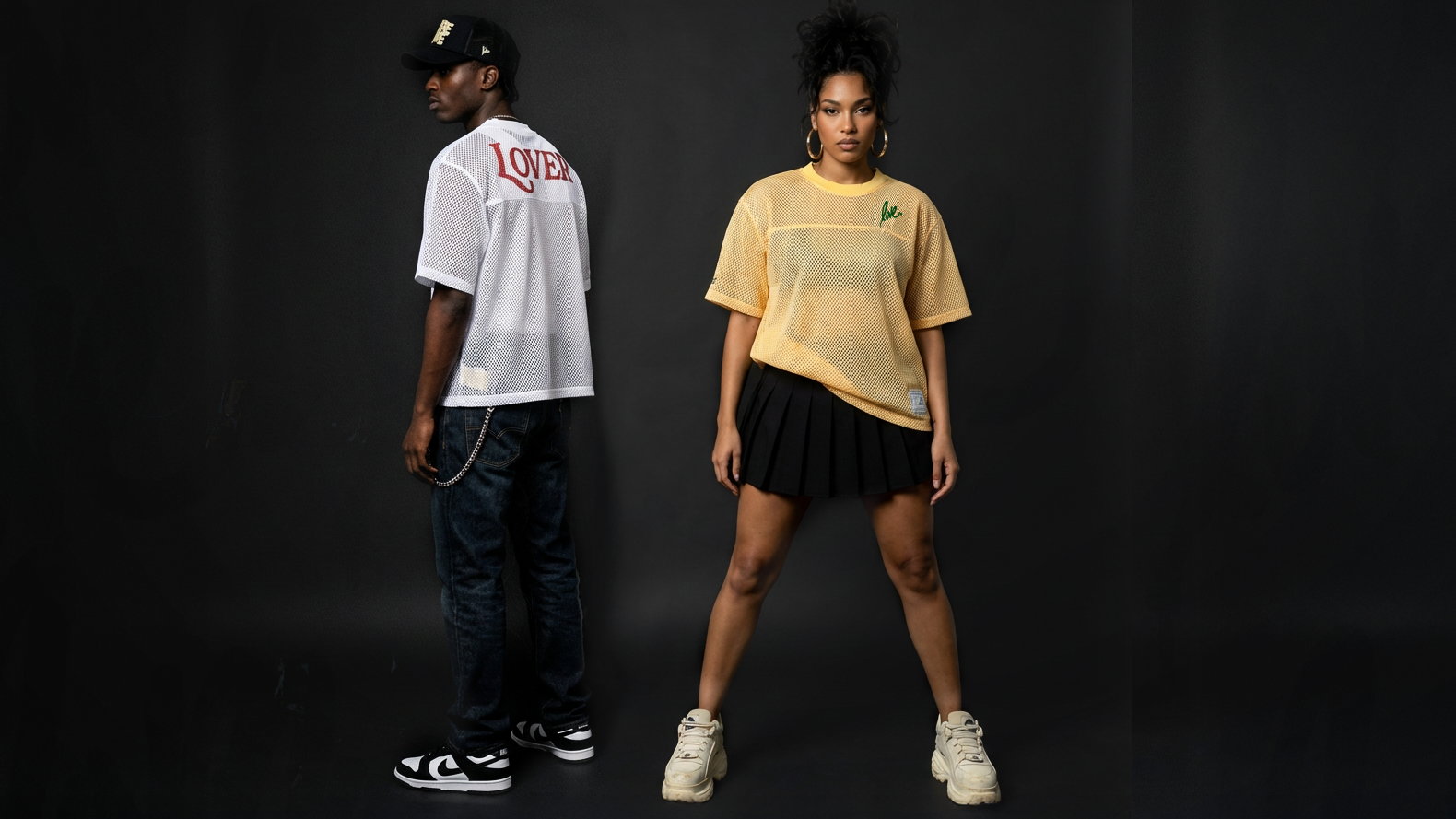 Two people wearing casual outfits against a black background